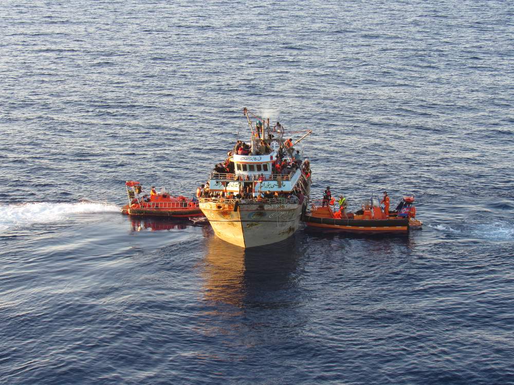 Coming to the rescue: Norwegian vessels helping a boat full of refugees and migrants as part of Frontex's Operation Triton. Photo via 