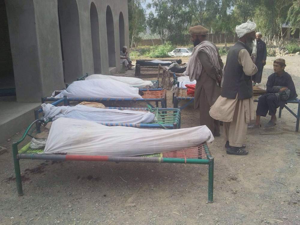 Bodies of men said to have been killed in the strike await burial